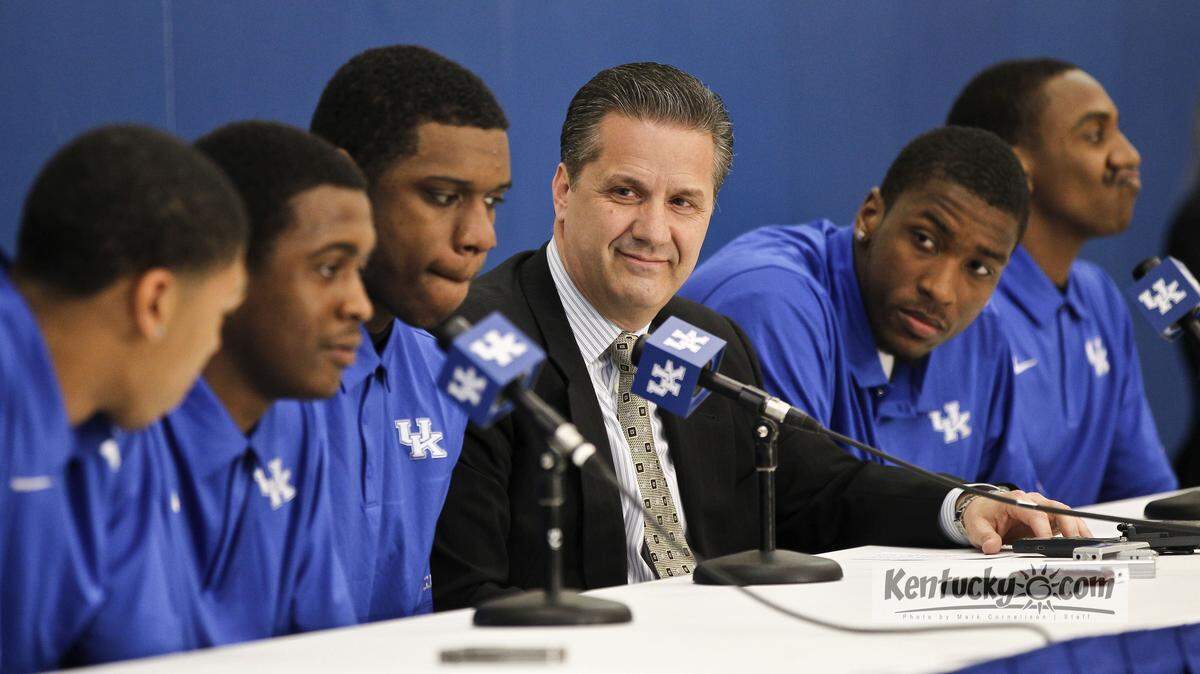 Kentucky coach John Calipari  listens as Doron Lamb makes comments as Calipari announced that Anthony Davis, left, Doron Lamb,  Terrence Jones, Michael Kidd-Gilchrist  and Marquis Teague will enter the NBA draft in  a press conference on Tuesday  April 17, 2012 in Lexington, Ky. Photo by Mark Cornelison | Staff