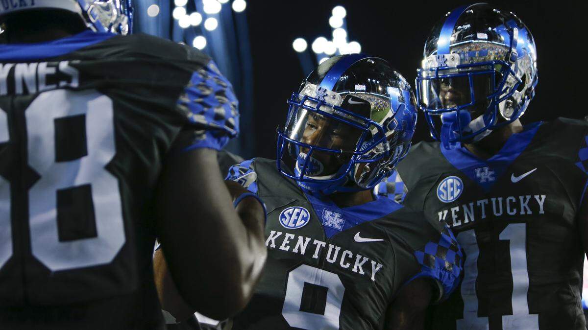 Kentucky wide receiver Garrett Johnson (9) celebrated with guard Nick Haynes (68) and wide receiver Tavin Richardson (11) after scoring a touchdown against Florida on Sept. 23, 2017, in Lexington.