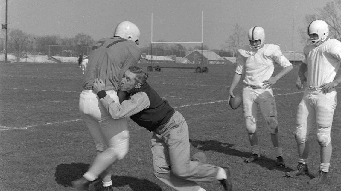 Kentucky Coach Charlie Bradshaw gave a blocking demonstration on Paul Pisani, a sophomore. Bradshaw was unhappy with UK's blocking assignments.  