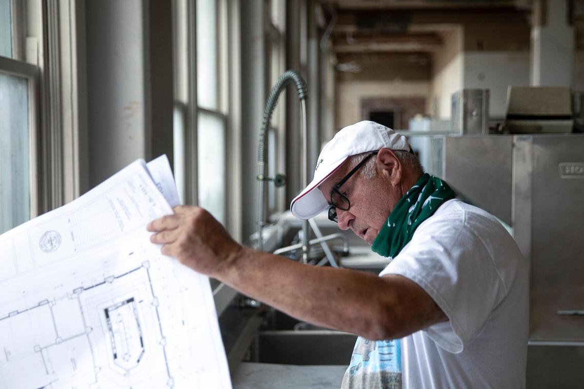 Frank & Dino’s owner Carlo Vaccarezza looks at construction plans Friday, July 24.