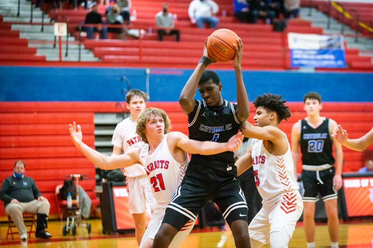 John McCrear battled two Lincoln County defenders during Lexington Catholic’s 63-45 victory on Tuesday night.