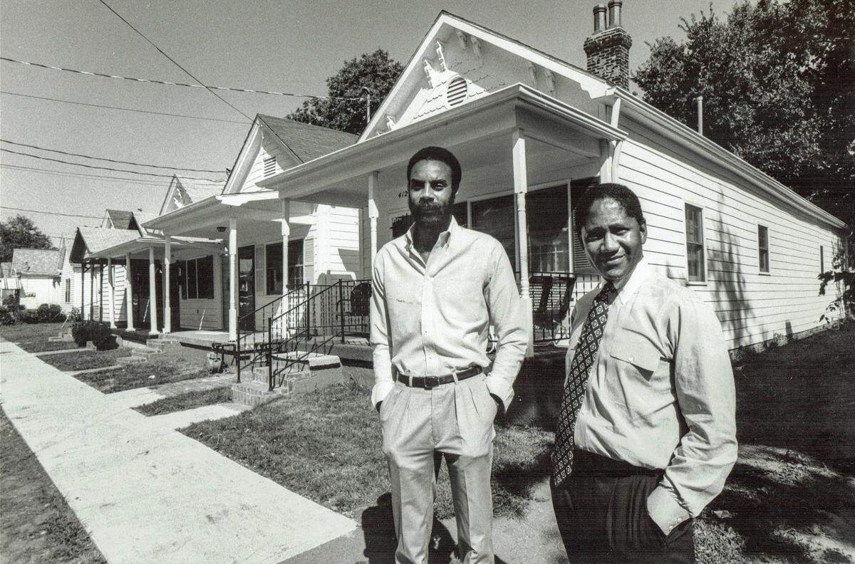 Ed Holmes, left, a local developer, and P.G. Peeples, Sr., executive director of the Urban League, stood in front of a row of houses on July 16, 1985. The Urban League had purchased the houses on Chestnut Street to fix them up.