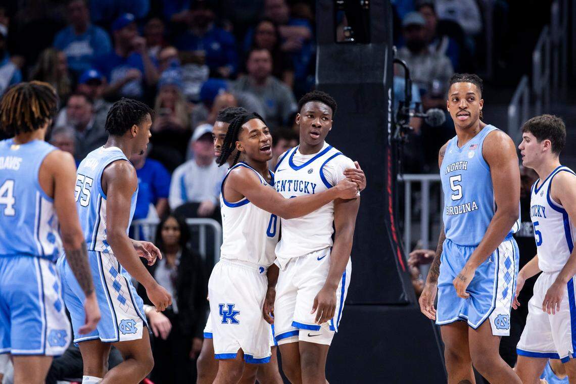 Kentucky’s Rob Dillingham, left, grabs Adou Thiero after a play against North Carolina during the the CBS Sports Classic. Dillingham led UK with 17 points. Thiero had a game-high four blocked shots.