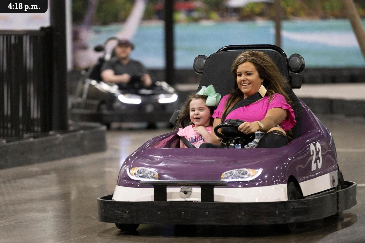 Harper Branham, left, smiles big in the passenger seat of a go-kart as her mother Ashley Branham, right, steers it around tight corners and past slower drivers at Malibu Jack’s Friday, July 9. The indoor theme park, which opened 2018 in a former K-Mart store on Nicholasville Road, has attractions like electric go-karts, a small roller coaster, mini golf, bowling and several arcade style machines. The park was bustling full of energy and noise as guests of all ages enjoyed the attractions the Friday afternoon. Ashley was with her husband, Brandon, from Paintsville to let their twin children play on the attractions. “We celebrated their third birthdays here the year before as well.”