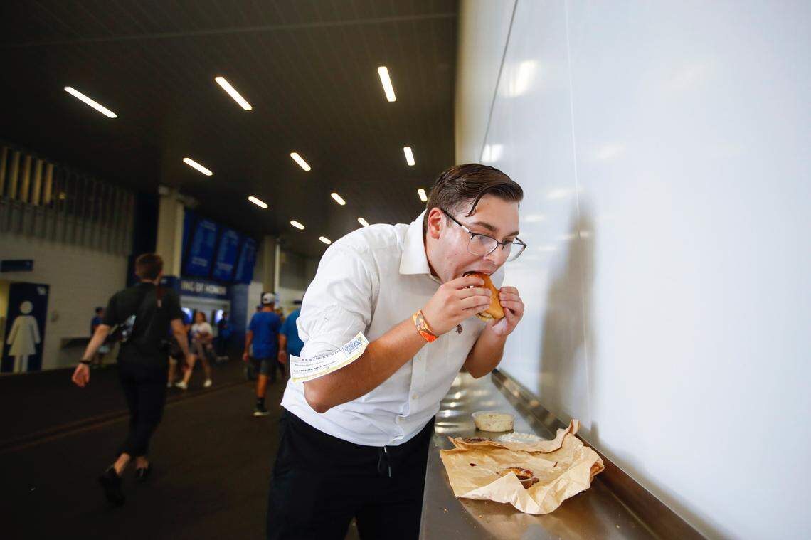 Herald-Leader reporter Cameron Drummond tries out a pulled pork sandwich from City Barbeque, a new concession stand option at Kroger Field.