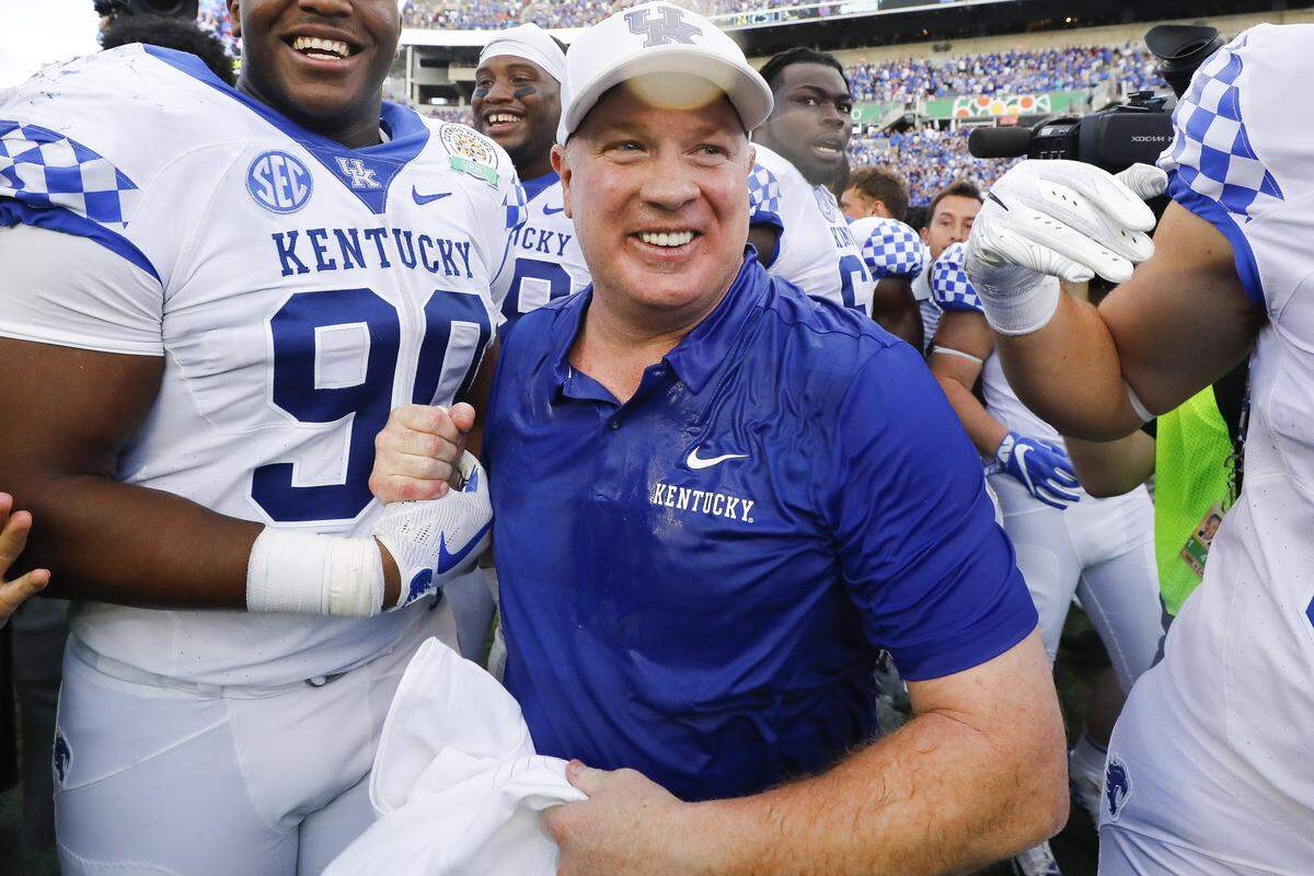 Kentucky Coach Mark Stoops celebrated with his players after UK recorded its first New Year’s Day bowl victory since 1952 with a 27-24 win over Penn State in the VRBO Citrus Bowl.