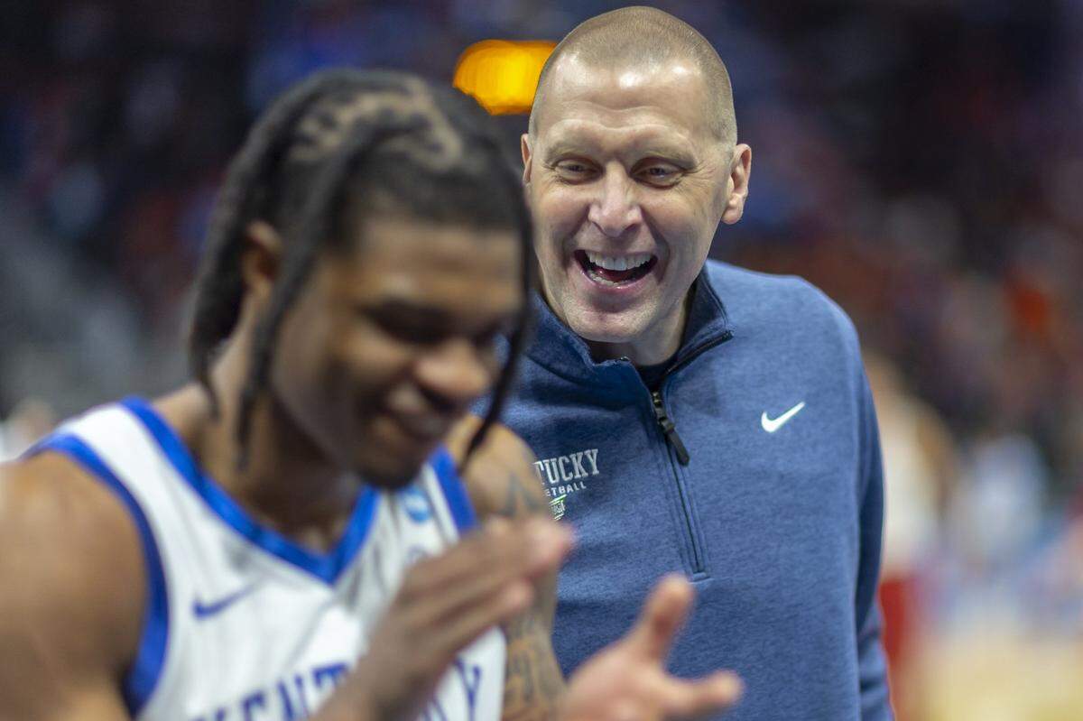 Kentucky head coach Mark Pope celebrates with Otega Oweh following a second-round NCAA Tournament victory against Illinois at Fiserv Forum in Milwaukee on Sunday.