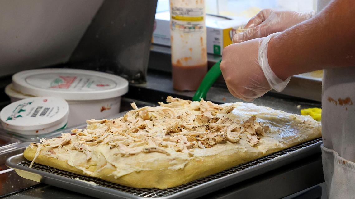 A Tito pizza with house cream sauce, chicken, banana peppers and Sav’s habanero sauce, being made at Dingbats Pizza, located at 471 Jefferson St., Thursday, Oct. 24, 2024 in Lexington, Ky.