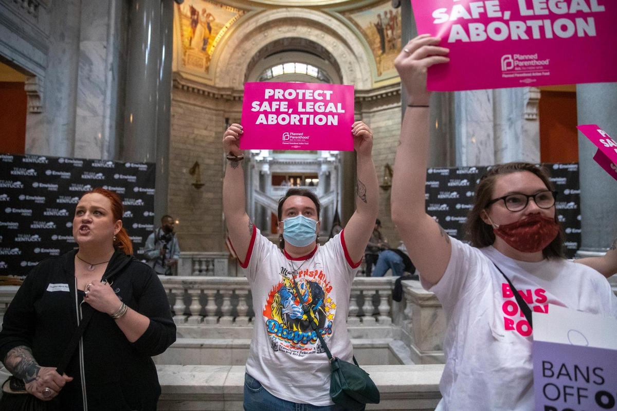 Jace Peters-White of Lexington, center, joined others protesting at the Kentucky state Capitol in Frankfort, Ky., on Wednesday, April 13, 2022. Protesters chanted “Bans off our bodies” as they anticipated Kentucky Gov. Andy Beshear’s veto of a sweepingly restrictive abortion bill, HB3, would be overridden.