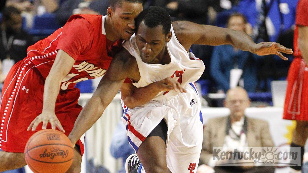 Madison Central's Dominique Hawkins  stole the ball from Holmes' Daquan Palmer as Madison Central defeated Holmes 65-61 on Friday March 7, 2013 in Lexington, Ky. Photo by Mark Cornelison | Staff