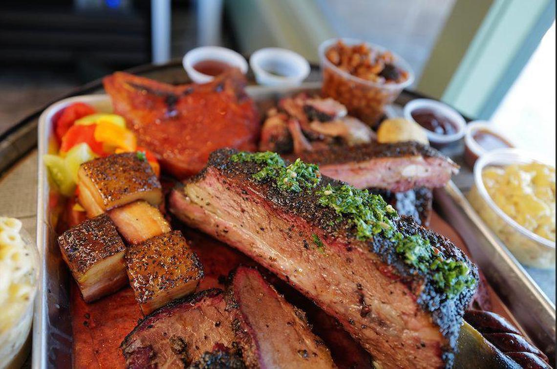A beef rib with chimichurri from LX BBQ. To the left of the beef rib is pork belly burnt ends. Both will be special menu items and subject to availability.
