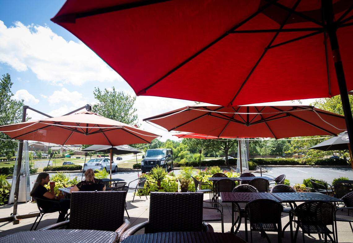 Patrons dine outdoors on the patio July 27 at J. Render’s Southern Table & Bar.