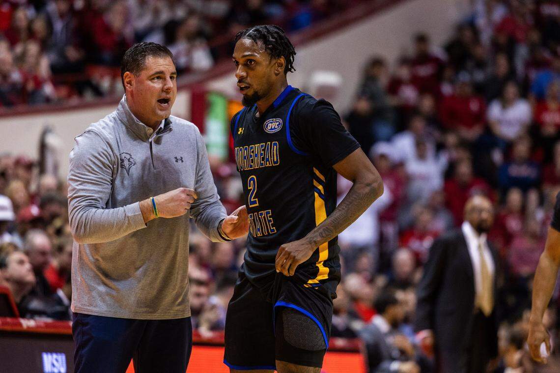 Morehead State head coach Preston Spradlin, left, talks with guard Jordan Lathon during a game against Indiana on Dec. 19, 2023.