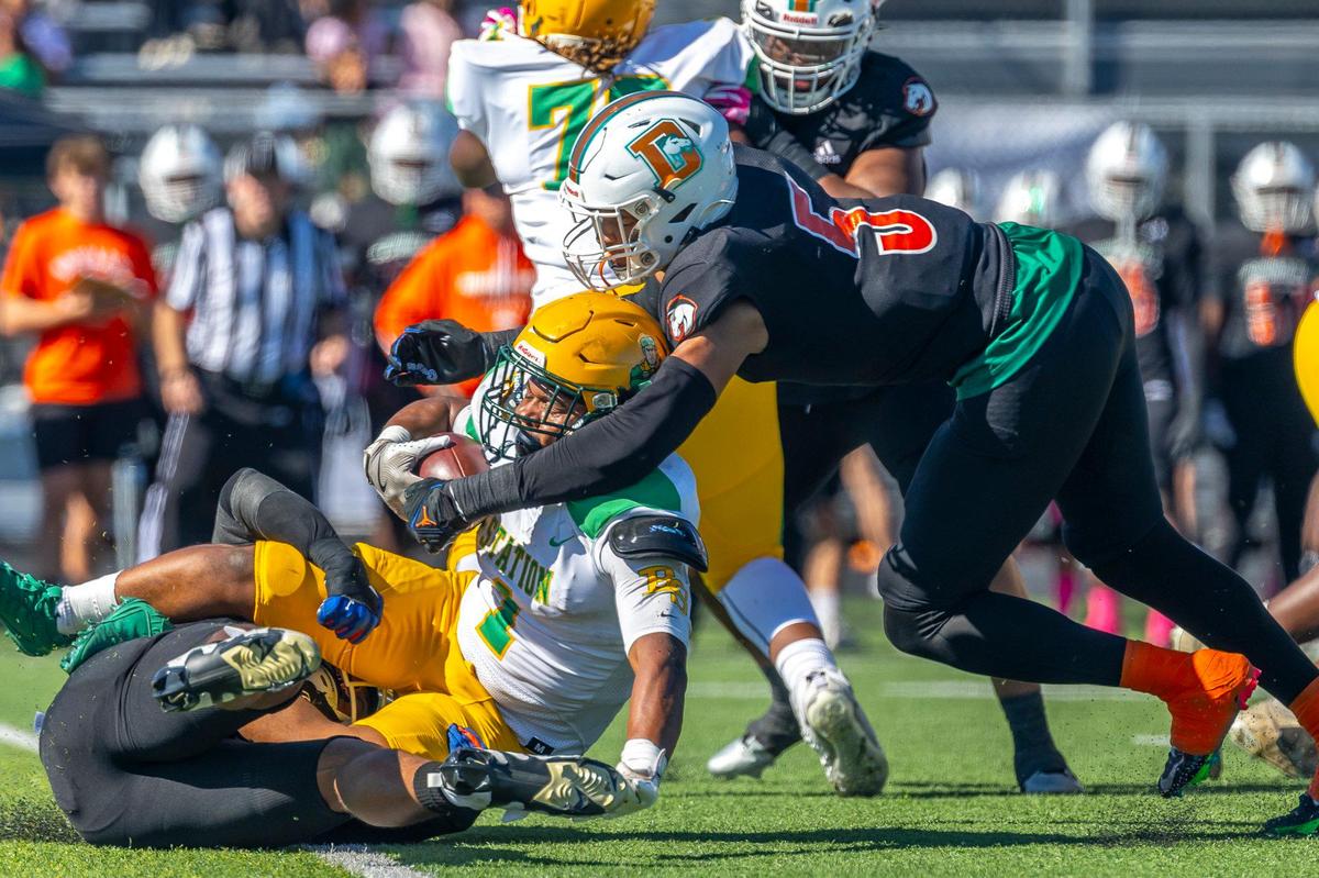 Frederick Douglass’ Cedric Works (5) tackles Bryan Station’s Kalen Washington (1) during Saturday’s game.