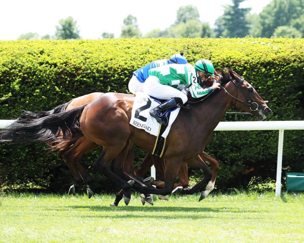 Enola Gay (2) narrowly defeated Walk In Marrakesh and Alms in a three-horse photo finish in the $150,000, Grade 2 Appalachian Stakes at Keeneland on Saturday.