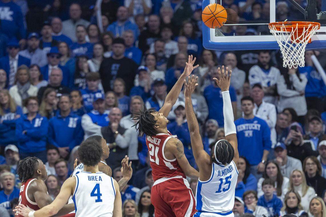 Arkansas guard D.J. Wagner (21) shoots the ball over Kentucky forward Ansley Almonor (15) during Saturday’s game at Rupp Arena.