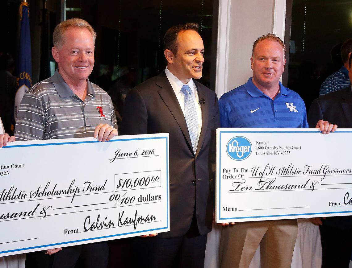 Louisville Coach Bobby Petrino, left, and Kentucky coach Mark Stoops, right, at the 2016 Governor’s Cup Luncheon with Kentucky Gov. Matt Bevin, center.