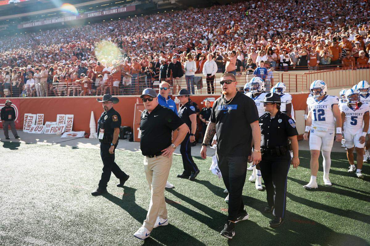Kentucky head coach Mark Stoops walks onto the field ahead of Saturday’s game against Texas.