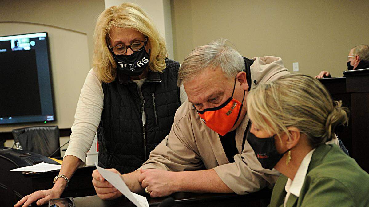 Sen. Robin Webb, Senate President Robert Stivers and Sen. Julie Raque Adams review part of the state budget during a break of the budget conference committee on March 9.