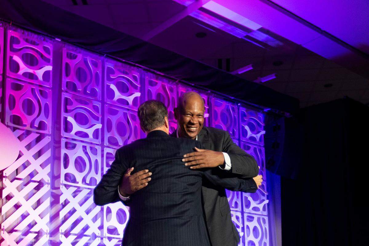 Louisville men’s basketball coach Kenny Payne hugs Kentucky head coach John Calipari after both spoke at the Kentucky Chamber Annual Dinner at Louisville Marriott Downtown on Sept. 14.