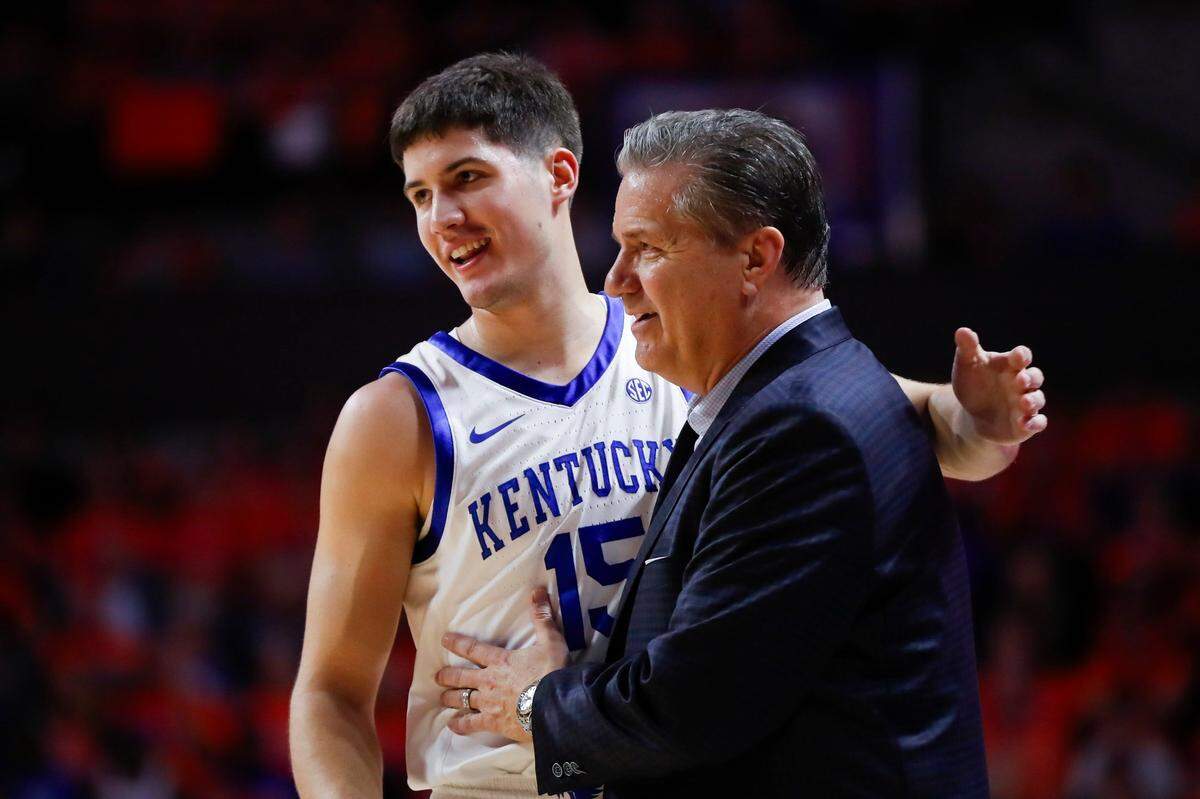 Kentucky guard Reed Sheppard (15) talks to Kentucky coach John Calipari in between plays against Florida during Saturday’s game.