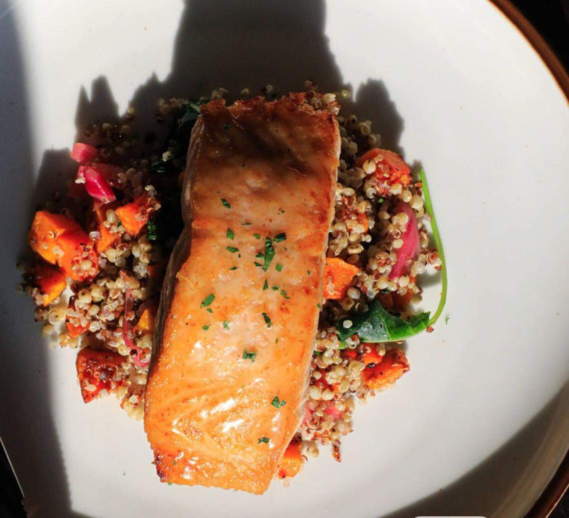 Millstone’s seared salmon ($38) with quinoa, sorghum, squash, kale, pepita, pickled onion, apple, goat cheese and honey vinaigrette. 