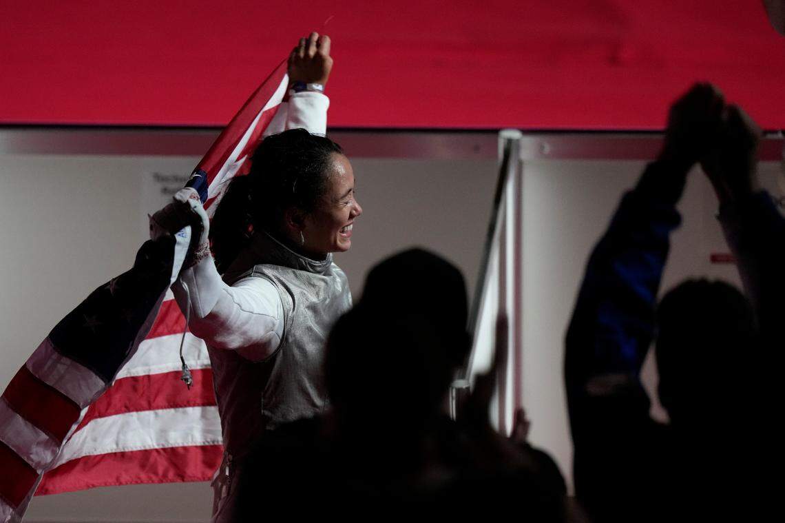 Lee Kiefer celebrated with the American flag after winning the gold medal in the women’s individual foil competition at the Summer Olympics on Sunday in Chiba, Japan.