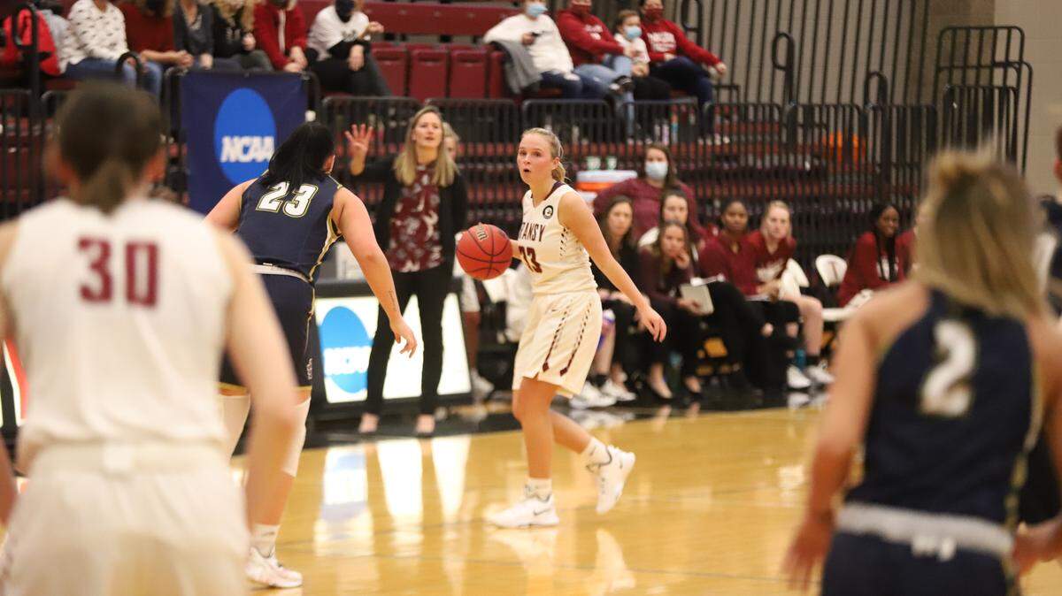 Transylvania sophomore Kennedy Harris dribbles the ball as head coach Juli Fulks calls out a play in the background during a Dec. 20 home game against John Carroll. Fulks is 161-37 overall at Transy and is in her eighth season coaching the Pioneers.