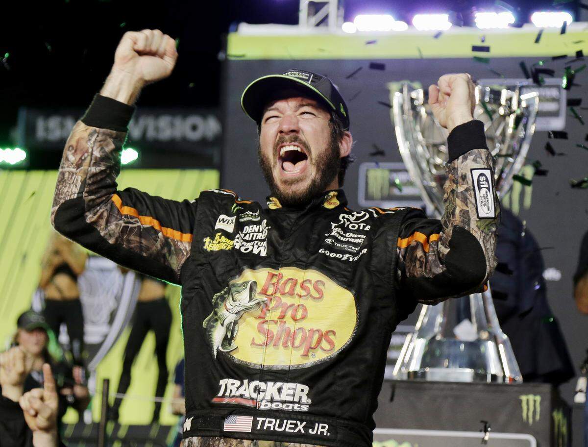 Martin Truex Jr. celebrated in Victory Lane after winning the 2017 NASCAR Monster Energy Cup Series championship by holding off Kyle Busch to win the final race of the season at Homestead-Miami Speedway.