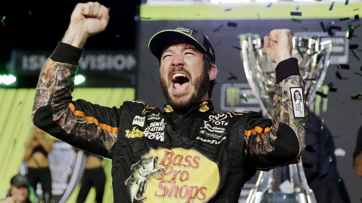 Martin Truex Jr. celebrated in Victory Lane after winning the 2017 NASCAR Monster Energy Cup Series championship by holding off Kyle Busch to win the final race of the season at Homestead-Miami Speedway.