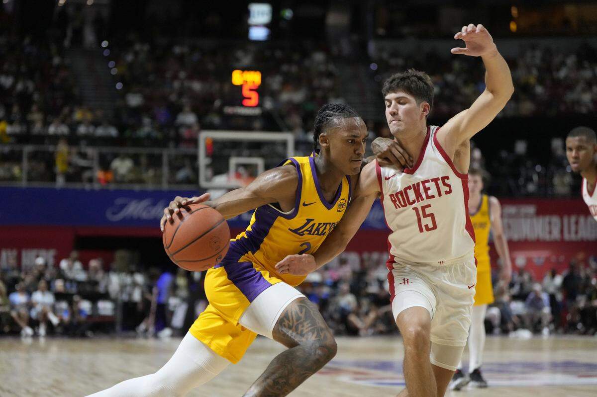 Lakers forward Maxwell Lewis drives against Reed Sheppard on Friday night. Defensively, the rookie from Kentucky finished with three blocked shots and a steal.