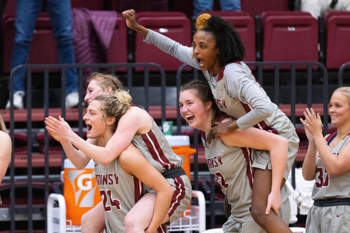Transylvania forward Dasia Thornton, top right, forward Laken Ball, bottom right, guard Madison Kellione, top left, and guard Kennedi Stacy, bottom left, celebrate after Transylvania won the Heartland Collegiate Athletic Conference Tournament championship Saturday.