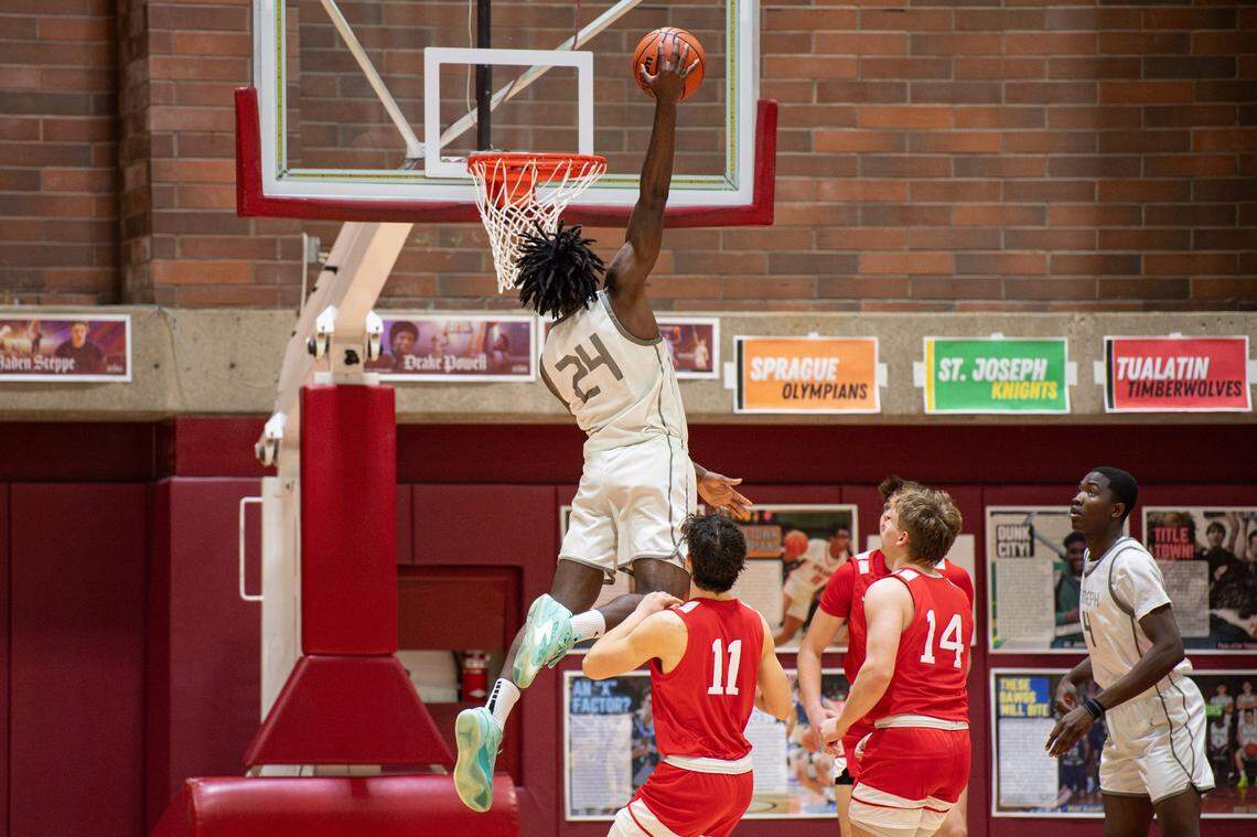 St. Joseph's Tounde Yessoufou (24) attempts to dunk the ball during the first round of the Capitol City Classic at Willamette University on Saturday, Dec. 16, 2023, in Salem, Ore.