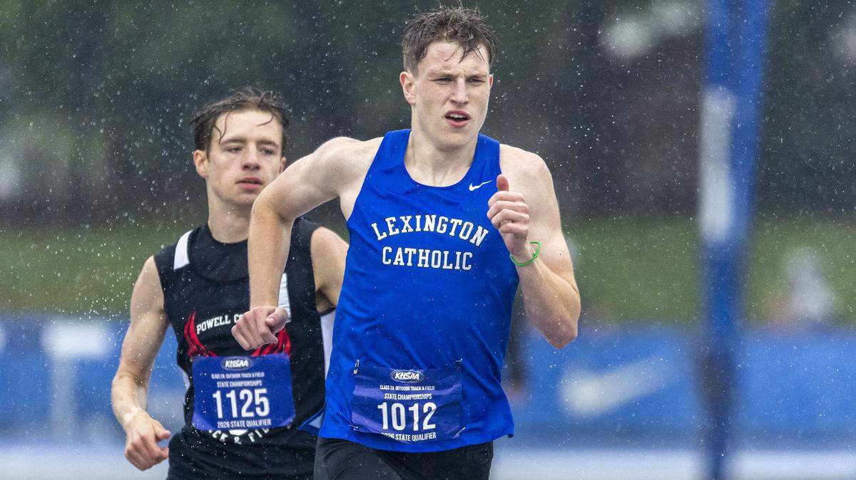 Lexington Catholic's Asher Feddock, right, won the boys 800 meter run in a rainstorm during the 2026 KHSAA Boys and Girls Class 2A State Track and Field Championships at the University of Kentucky track and field complex in Lexington, Ky., on Friday, May 22, 2026.