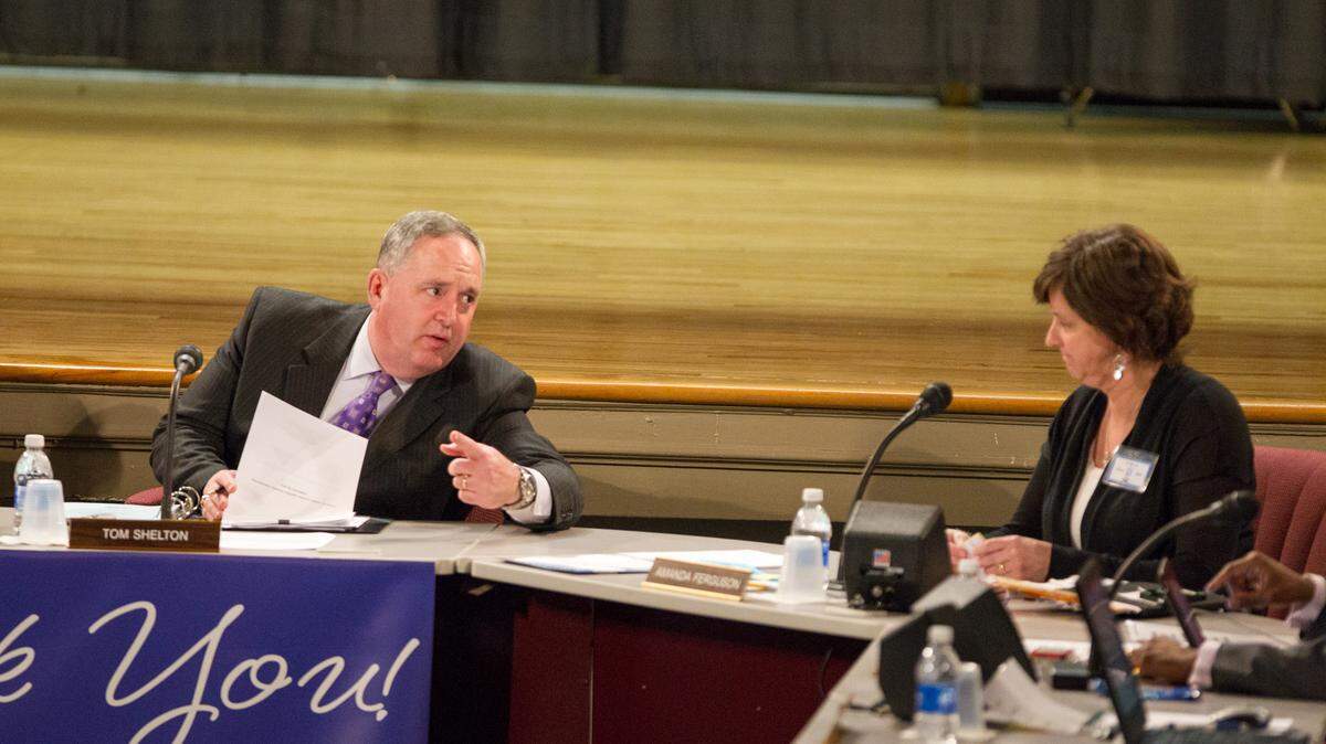 Superintendent Tom Shelton talked to board member Amanda  Ferguson before calling the school board  meeting to order Monday night.