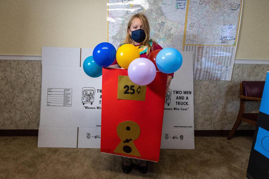 Eight-year-old Carly Klinglesmith in her homemade gumball Halloween costume which was made from repurposed cardboard boxes. He mom, who works Two Men and a Truck offices on Westland Drive created the “Boxtumes.”