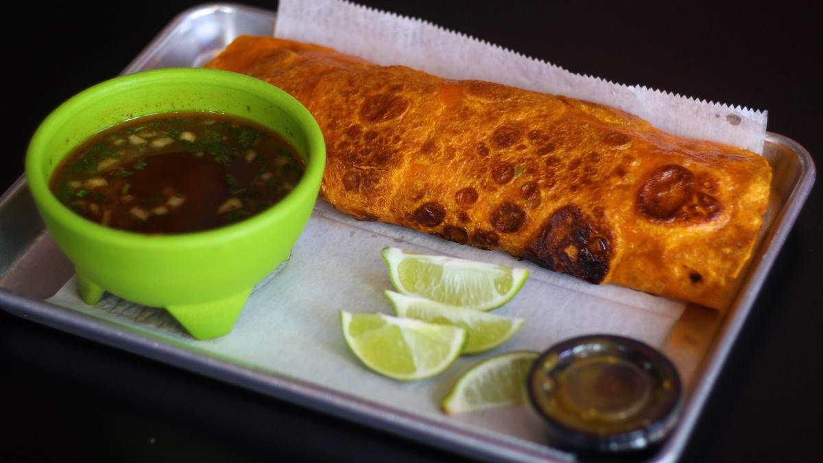 El Cid’s barbacoa meat burrito also comes with a side of consomme to dip into or eat separately.