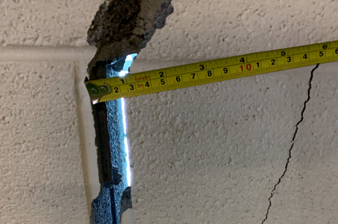 Daylight shows through a cracked wall in the Knott County Sportsplex.