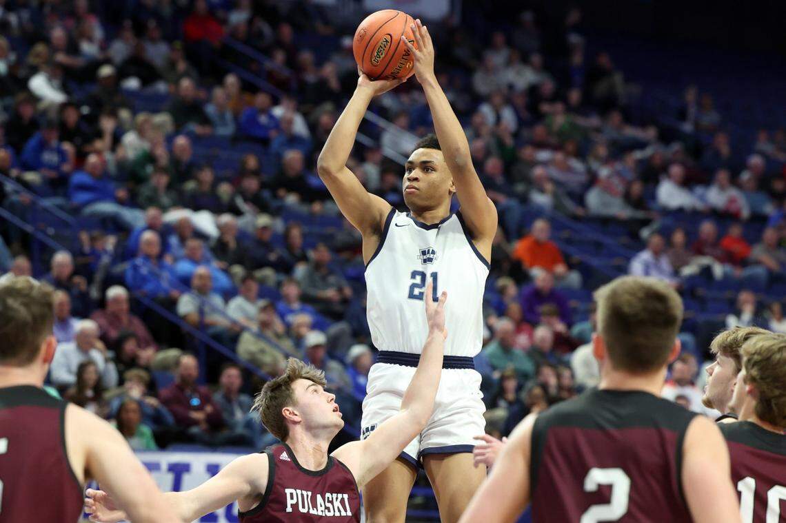 Warren Central’s Chappelle Whitney (21) shoots over the Pulaski County defense during the Dragons’ first-round victory on Wednesday in Rupp Arena.