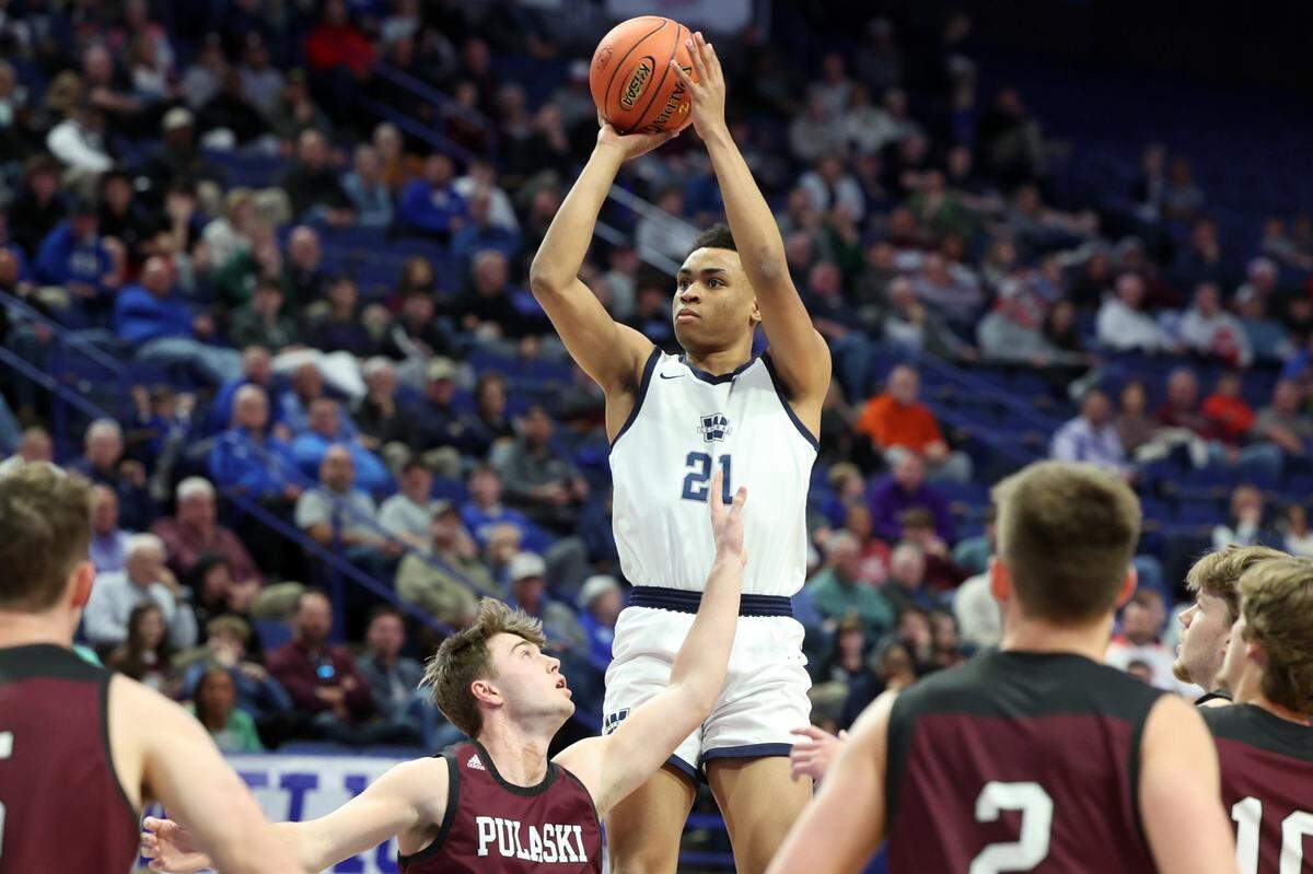 Warren Central’s Chappelle Whitney (21) shoots over the Pulaski County defense during the Dragons’ first-round victory on Wednesday in Rupp Arena.