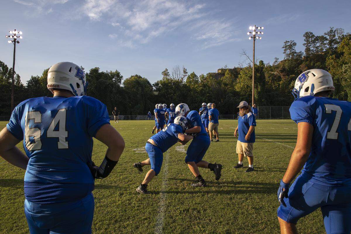 Breathitt County players perform drills while warming up for their game against the Cardinals.