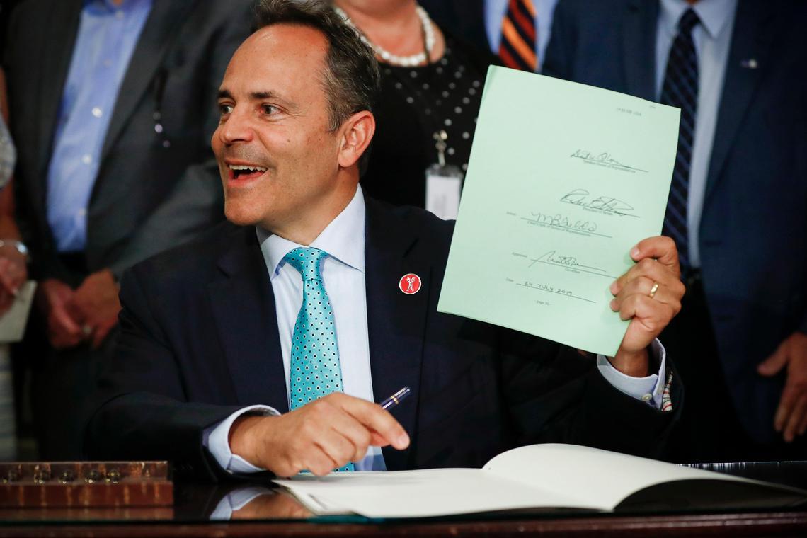 Kentucky Gov. Matt Bevin signs House Bill 1 into law in the Capitol Rotunda in Frankfort, Ky., Wednesday, July 24, 2019. The bill provides financial incentive for regional universities and quasi-governmental agencies to leave the state pension system.