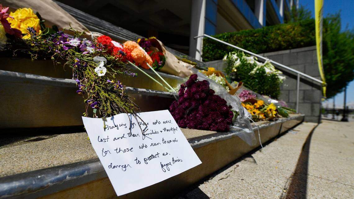 Flowers and a message of hope sit on the steps of the Old National Bank in Louisville, Ky., Tuesday, April 11, 2023. On Monday, a shooting at the bank located in downtown Louisville killed several people and wounded others. TIMOTHY D. EASLEY AP
