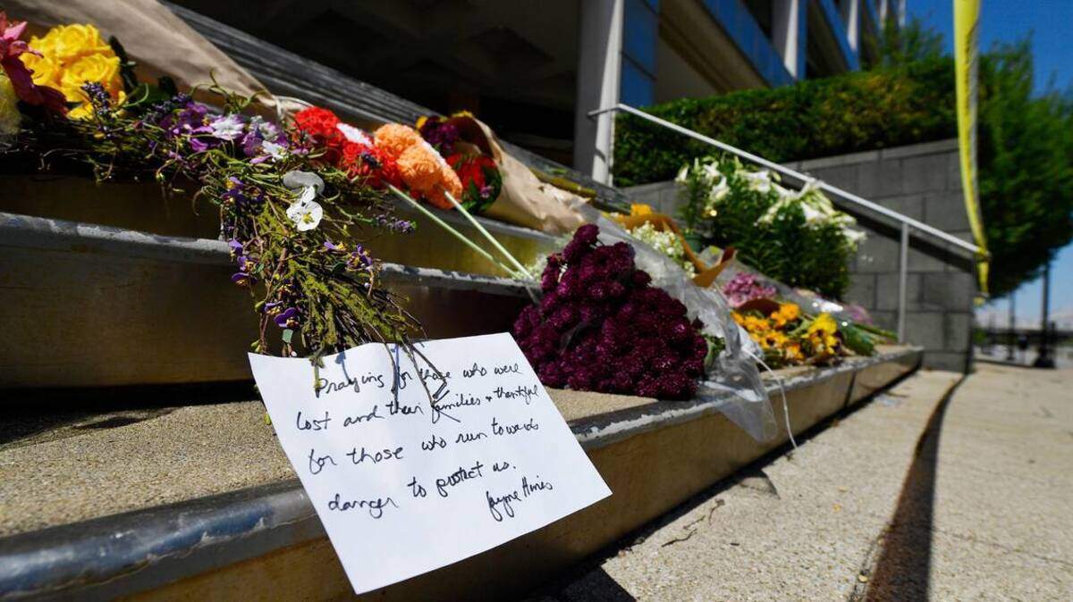 Flowers and a message of hope sit on the steps of the Old National Bank in Louisville, Ky., Tuesday, April 11, 2023. On Monday, a shooting at the bank located in downtown Louisville killed several people and wounded others. TIMOTHY D. EASLEY AP