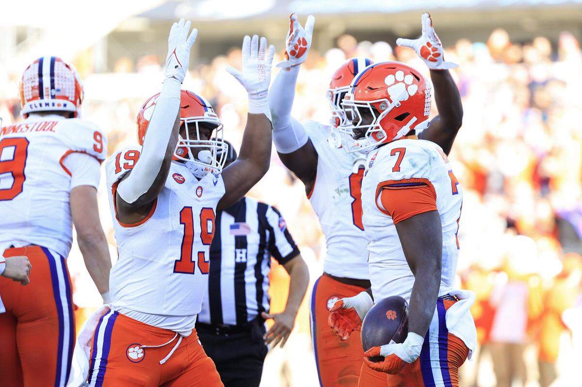 From left, Clemson Tigers running back Keith Adams Jr. (19) and wide receiver Adam Randall (8) celebrate a touchdown scored by running back Phil Mafah (7) during the fourth quarter of an NCAA football matchup in the TaxSlayer Gator Bowl Friday, Dec. 29, 2023 at EverBank Stadium in Jacksonville, Fla. The Clemson Tigers edged the Kentucky Wildcats 38-35. [Corey Perrine/Florida Times-Union]