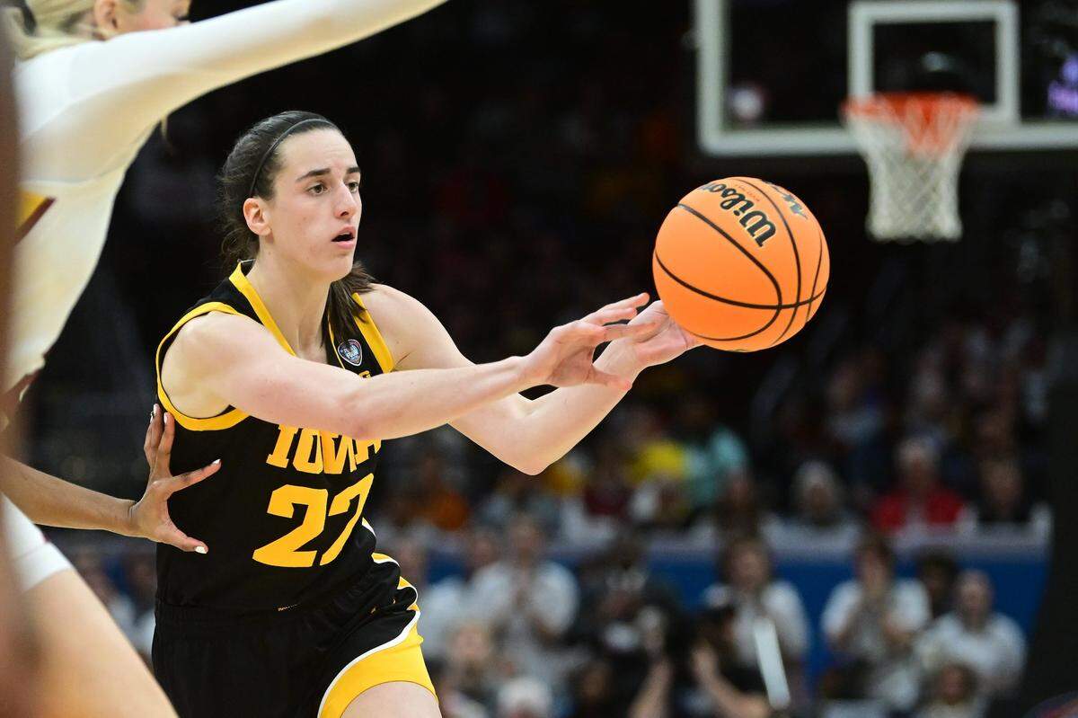 Apr 7, 2024; Cleveland, OH, USA; Iowa Hawkeyes guard Caitlin Clark (22) makes a pass against the South Carolina Gamecocks in the finals of the Final Four of the womens 2024 NCAA Tournament  at Rocket Mortgage FieldHouse. Mandatory Credit: Ken Blaze-USA TODAY Sports