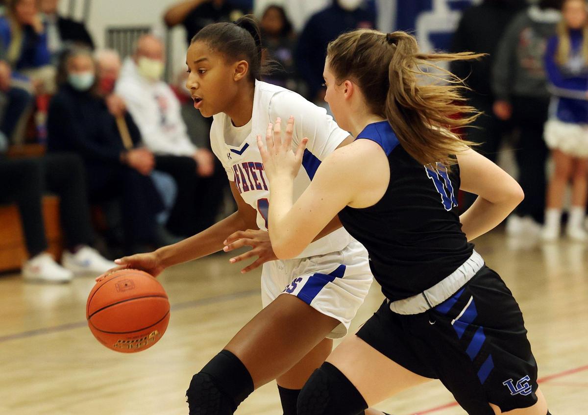 Lafayette’s Anaya Brown drives past Lexington Catholic’s Abby Hammond during Friday night’s Lafayette victory. Brown finished with 12 points and three blocks despite foul trouble and was named district tournament MVP.