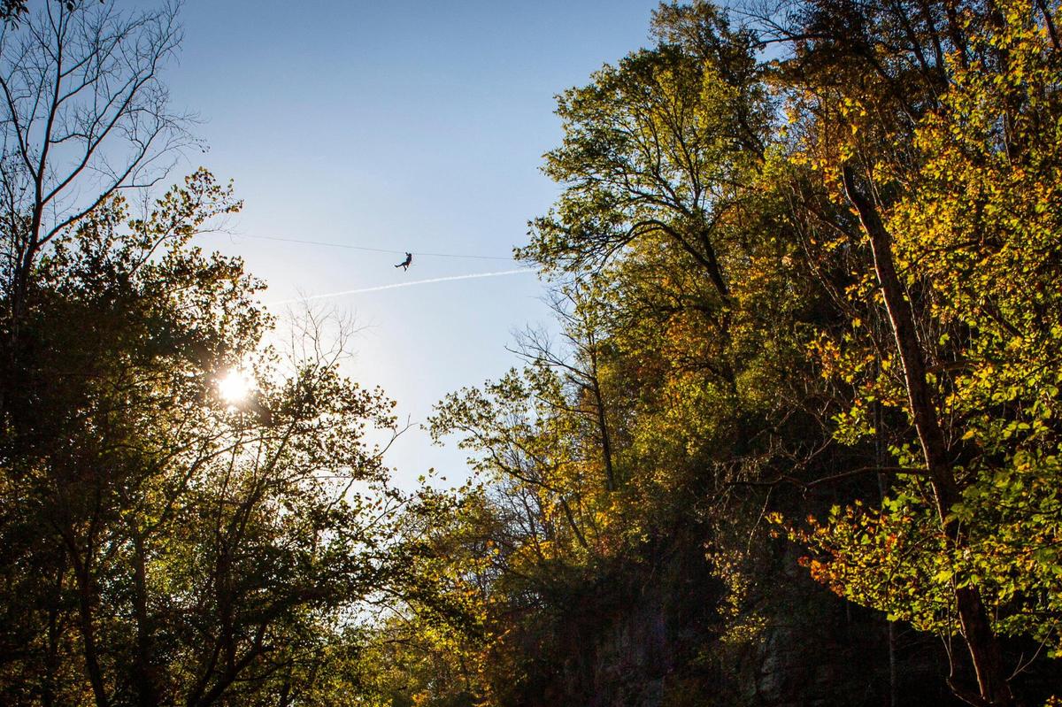 Jada McKenzie, a guide at Boone Creek Outdoors in Lexington, Ky., rides a zip across a quarry on Saturday, Oct. 17, 2020.