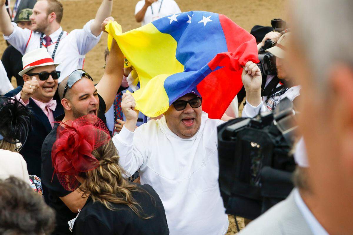 Some of Mage’s connections celebrate after he won the Kentucky Derby at Churchill Downs.