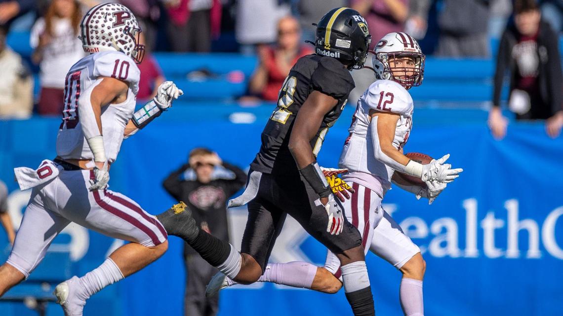Pikeville’s Blake Birchfield (12) runs the ball as Russellville’s Jackson Hampton (22) tries to chase him down during last year’s Class A state finals at Kroger Field.